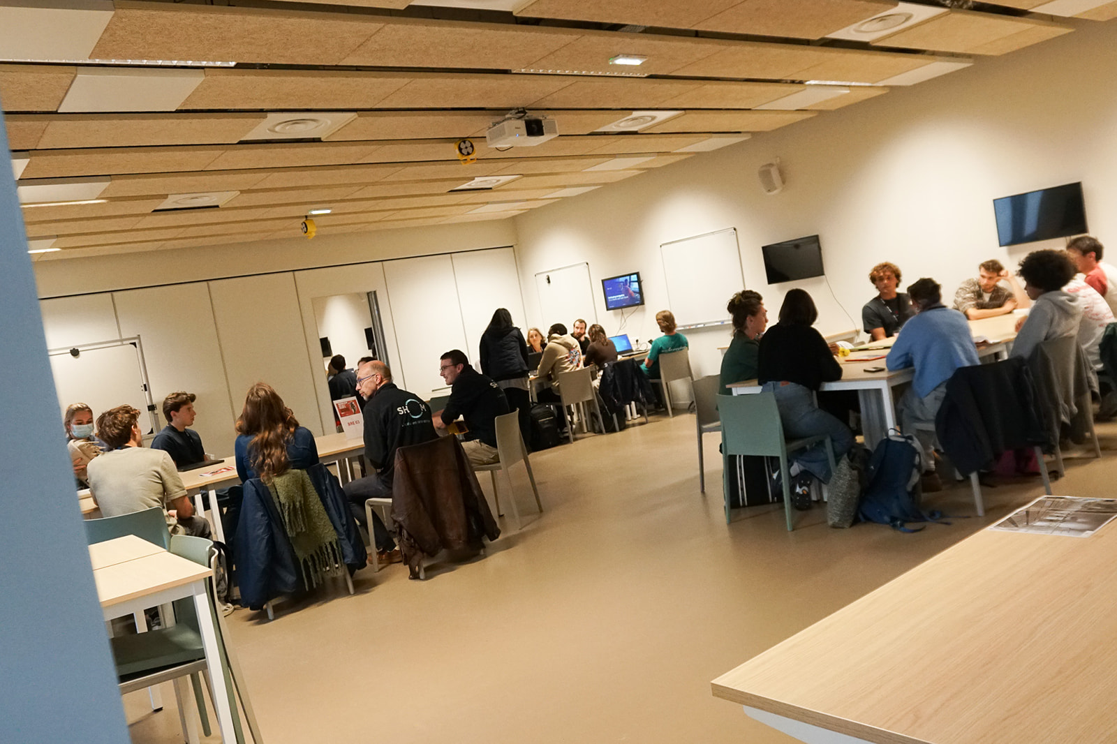 Plusieurs équipes réunies en îlots travaillent sur leurs différents défis lors d’Ocean Hackathon® Brest 2026.